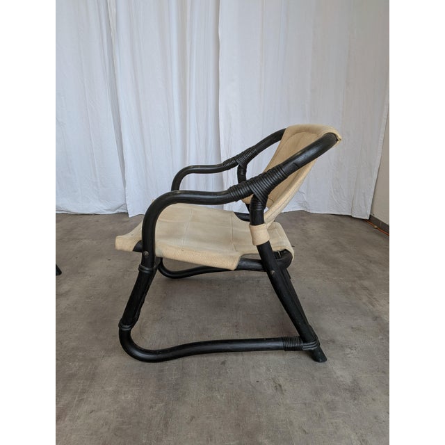Vintage chairs made from bamboo base in black and beige fabric. This chair is called Espri Safari, and it was designed and...