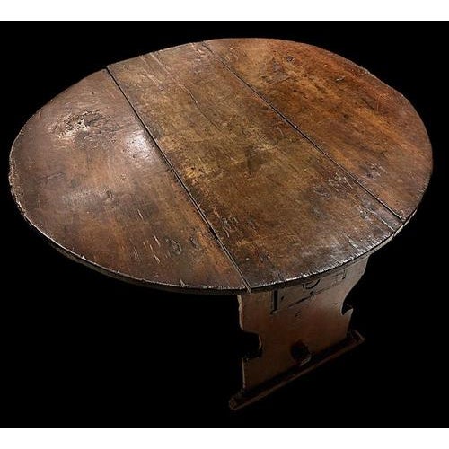 Interesting round table with opening and closing drop leaves, all in walnut wood, typical of the Umbrian or central...