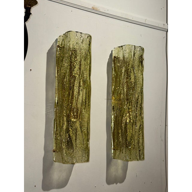 This product is a pair of square tube sconces made of Murano green granola glass. The unique handcrafted design adds a...