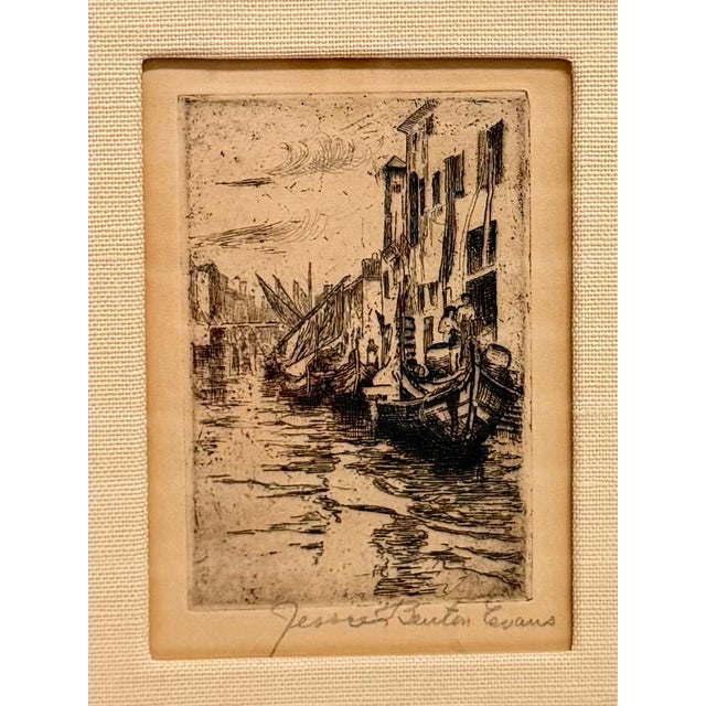 An original etching by noted American artist depicting an atmospheric Venetian canal lined with historic architecture and...