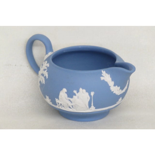 This lovely Creamer is made out of porcelain. This creamer is stamped as being made by Wedgwood in England in 1957, see...