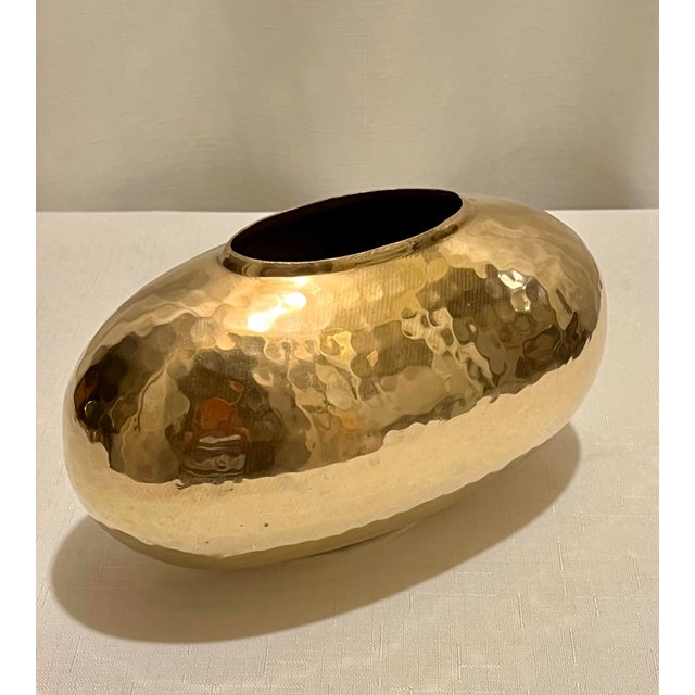 Welcome to Turtle and Crane. Allow us to introduce you to this exquisite Vintage Oval Hand Hammered Polished Brass Vase...