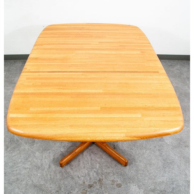 American designed kitchen dining table in solid oak wood w/ one extension leaf. The large butcher block surface sits upon...