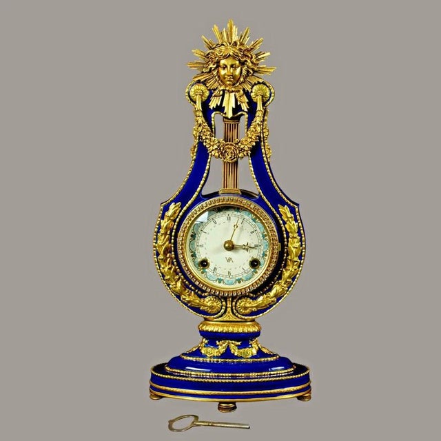 An elegant and highly decorative Marie Antoinette-style lyre mantel clock, inspired by an important French model held in...