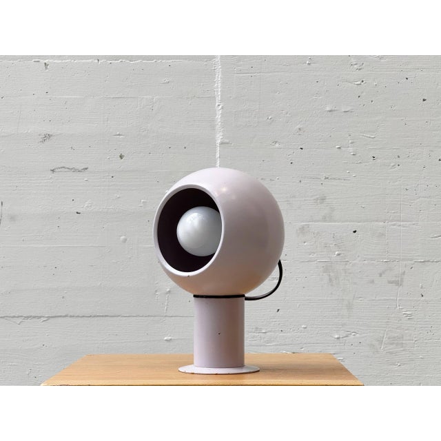 A sculptural pair of magnetic table lamps in the typical space age design of the 1970s. The spherical lamp heads are...