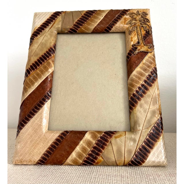 Faux leather picture frame with palm tree twine on upper hand corner. Great for beach home