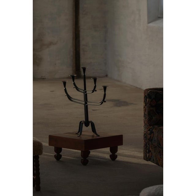A beautiful mid-century Brutalist candle holder crafted in wrought iron and mixed metals, embodying the sculptural...