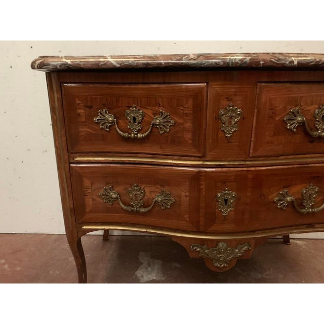Louis xv commode in veneered wood rosewood and violet wood veneer four cabriole legs with bronze sabots three drawers in...