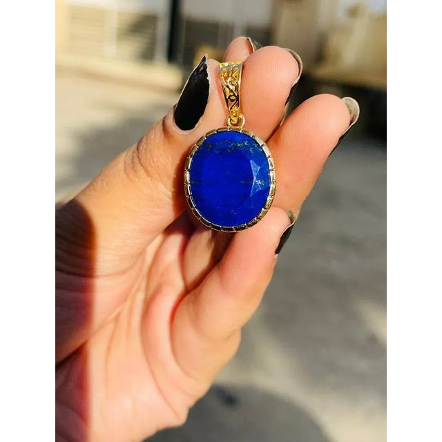 This is part of Chairish’s Fine Jewelry assortment. Lapis pendant in 18K Gold. It has a oval cut gemstone that completes...
