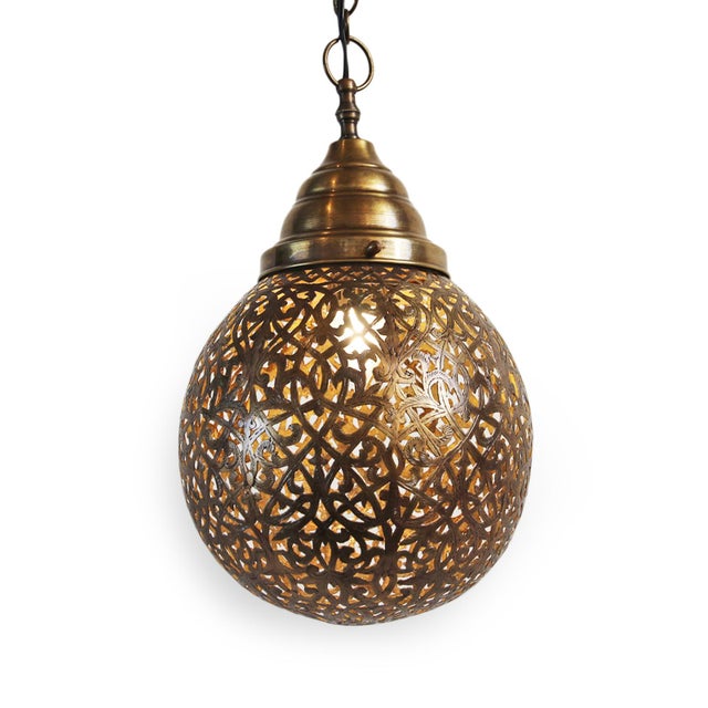 Stunning hand cut vintage Moroccan brass work pendant light. Perforated lace-like design which emits beautiful patterns on...
