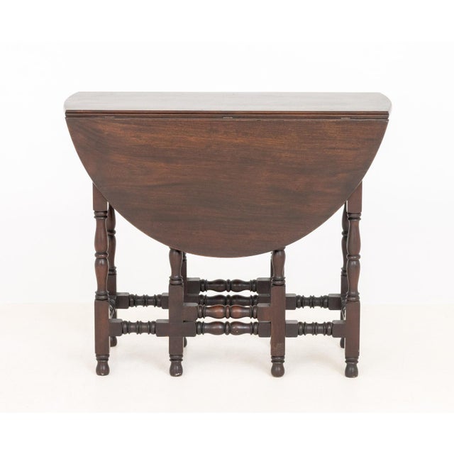 Jacobean Style Rosewood Gate Leg Drop Leaf Table, 19th century, the oval top above turned wood legs and single drawer....