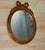 Vintage Italian Florentine Gilded Oval Mirror Ribbon Bow Accent Ornate oval wall mirror featuring a carved ribbon bow top,...