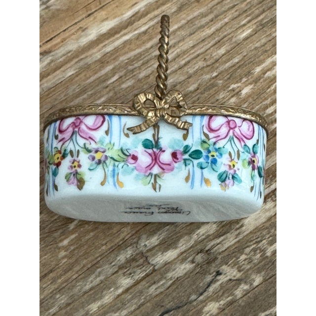 delicate Limoges basket with flowers authenticaed with the original Limoges trademark on the bottom.