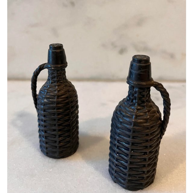 Vintage Demijohn metal salt and pepper shaker set in the shape of basket weave bottles. Each shaker has a screw top to add...