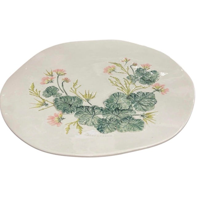 This vintage ceramic platter features a hand-painted botanical relief depicting Pelargonium (geranium) blooms and...