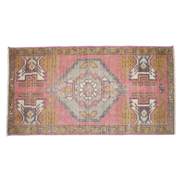 a Vintage Turkish Small yastik rug, rose color background rug perfect for entryway, bath or in front of the kitchen sink....
