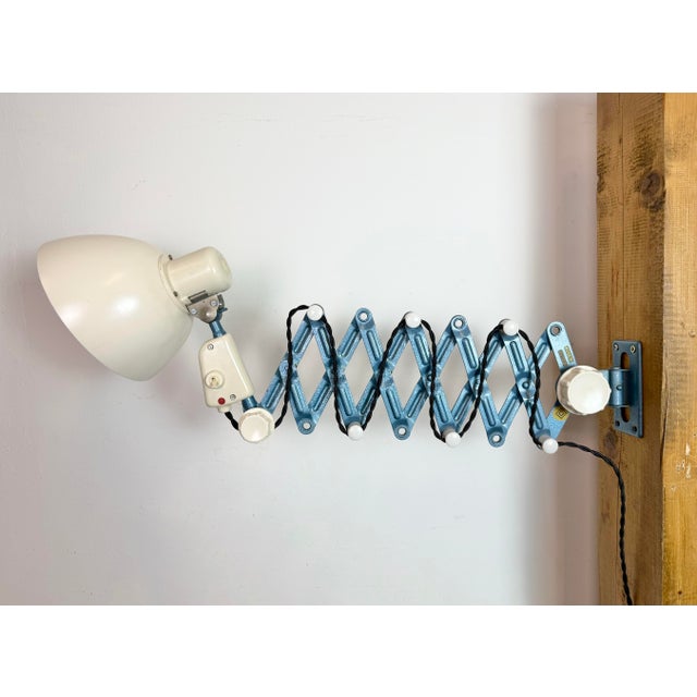 This vintage industrial scissor lamp was produced by reif dresden in former east germany during the 1950s. The lamp has a...