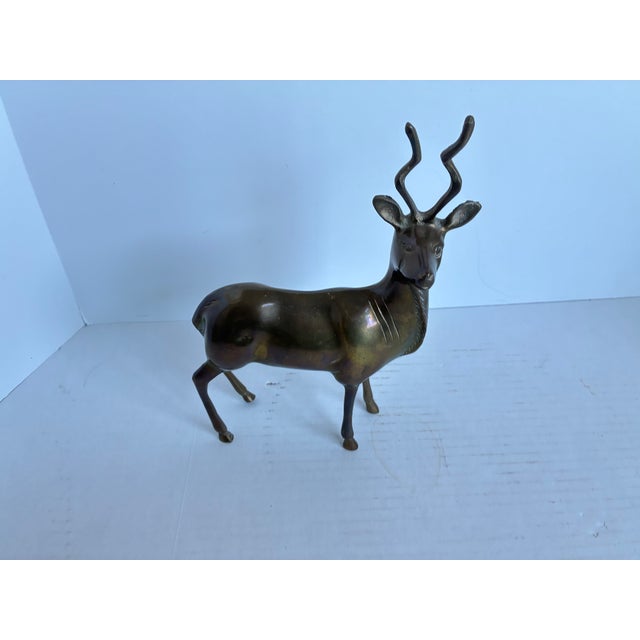 Vintage Mid-Century Modern brass antelope / gazelle figurine. Features distinctive spiral-shaped horns, typical of kudu or...