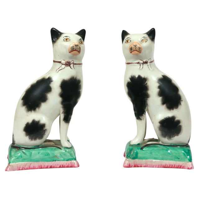 Staffordshire Pottery Cats on Cushions, Pair of Black and White Seated Figures, Circa 1860 Circa 1850–1870 Each cat is...