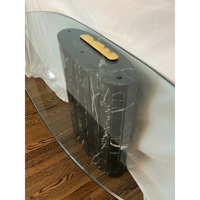 Stunning and dramatic postmodern style black marble veined console table with lightly bullnosed and polished edged glass...