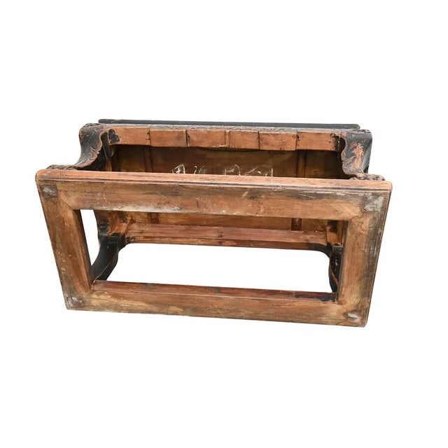This product is an antique Chinese low altar table from the early 19th century, adorned with a carved face. Made of wood...