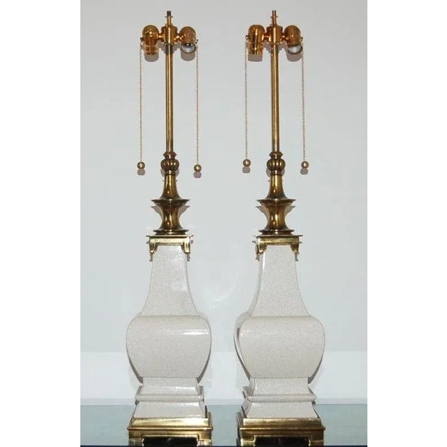 Stylish sculpted White ceramic lamps by Stiffel with craquelure. We have updated the glass globes by replacing them with...