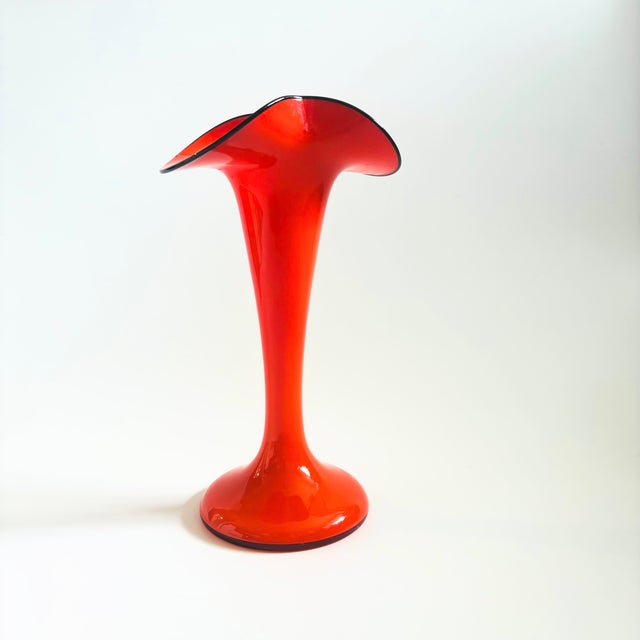 A vintage Art Deco "Tango" art glass vase by Franz Welz. Features a fluted shape and vibrant orange color with a...