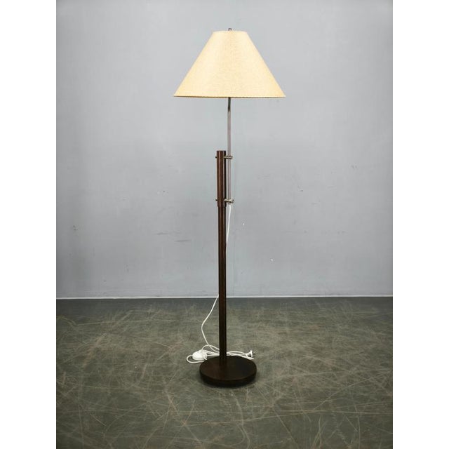 Striking adjustable floor lamp produced in germany during the 1970s, featuring an elegant combination of oak wood, metal...