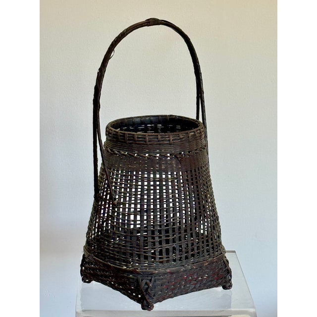 A finely woven basket with dark patinated. Made for Ikebana, the traditional Japanese art of flower arranging. Signed by...