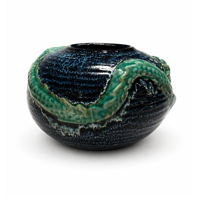 Description: Striking vintage studio pottery vase featuring a sculptural dragon motif wrapped along the body. This piece...