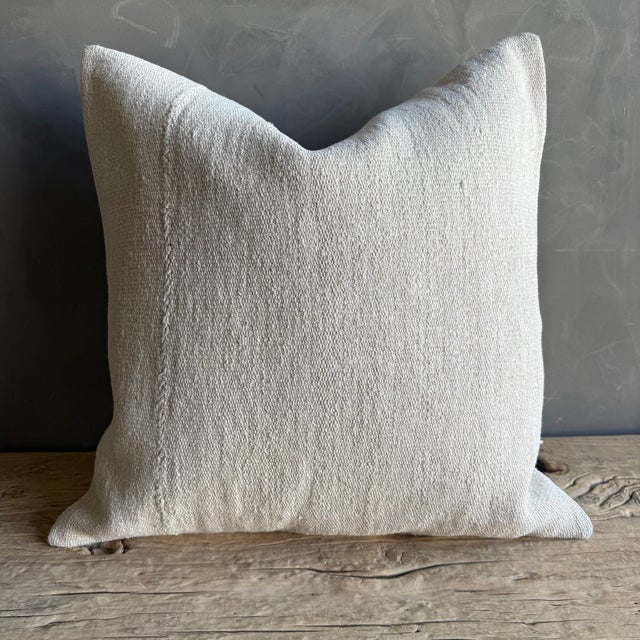 Creamy white hemp rug pillow with original seams. Soft hand, linen blend backing with zipper closure. Spot cleaning is...