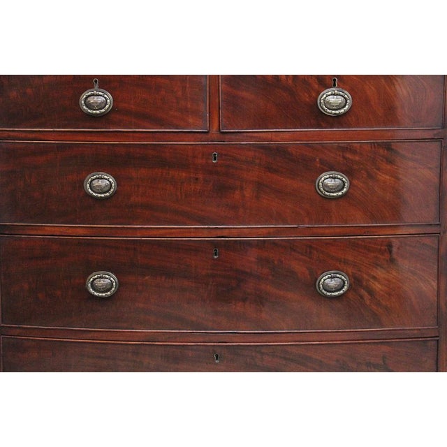 Early 19th Century mahogany bowfront chest of drawers, having a nice figured crossbanded top with a moulded edge above a...