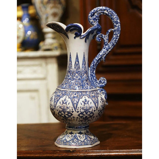 This elegant and colorful antique ewer was sculpted in Brittany, France, circa 1890. The unique large pitcher stands on a...