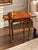 An exceptional neoclassical-style drink table attributed to Theodore Alexander, showcasing elaborate craftsmanship,...