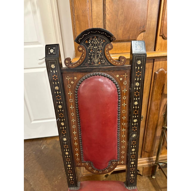 Set of four Moorish intricately inlaid game chairs with turned wood legs, stretcher base and leather seat and back in nail...