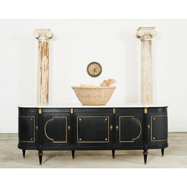 Dramatic grand French ebonized sideboard or buffet featuring a thick Carrara marble top slab. Beautifully crafted on a...