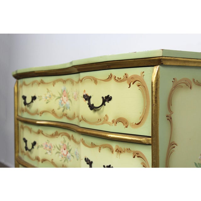 A romantic and elegant mid-20th century Venetian Baroque-style chest of drawers, finished in luxurious green lacquer with...