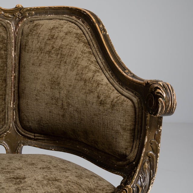 An elegant pair of Louis XV style armchairs featuring graceful curves and refined carved details. The upholstered seats...