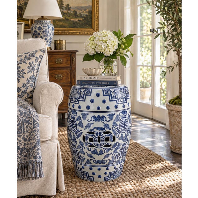 A classic blue and white porcelain garden stool, decorated with traditional Chinese motifs and stylized floral elements....