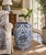A classic blue and white porcelain garden stool, decorated with traditional Chinese motifs and stylized floral elements....