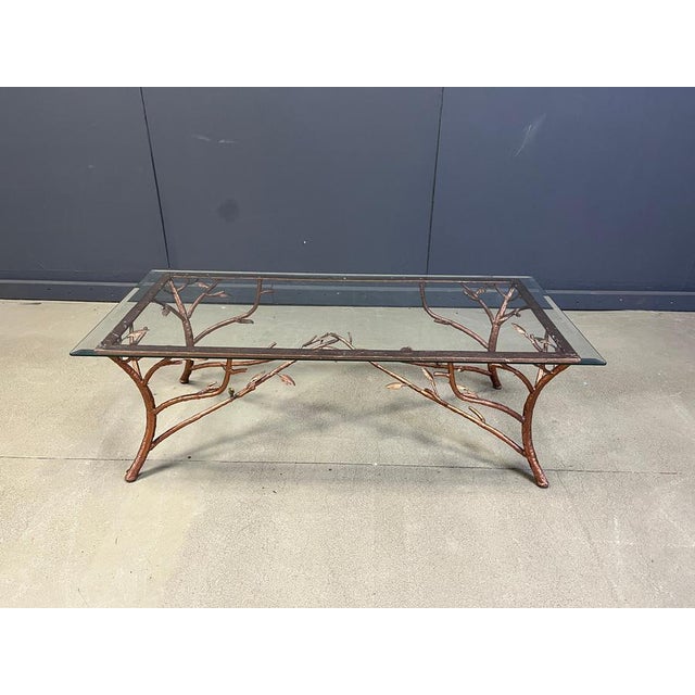 Hand crafted wrought iron coffee table depicting tree branches with a copper finish. Beautiful sculptural base with...