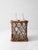 A vintage wicker bottle basket with four fitted glass bottles, woven in an open crisscross pattern that gives the piece a...
