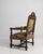 A stately Jacobean-style armchair crafted from oak, featuring bold carved details and a strong architectural frame. The...
