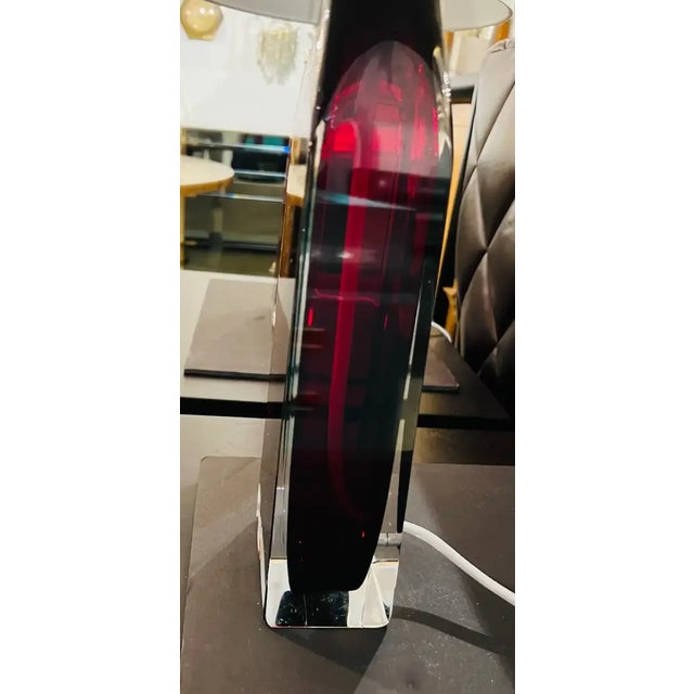 Pair of luxurious thick crystal tables lamps in a deep ruby red color and polished nickel fittings and sockets with white...