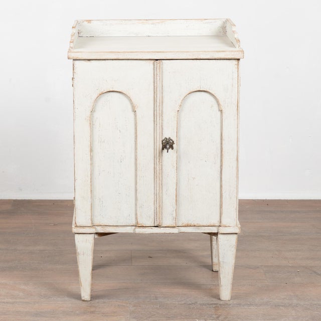 19th-century Swedish pine nightstand with a newer professionally applied antique white painted finish, lightly distressed...