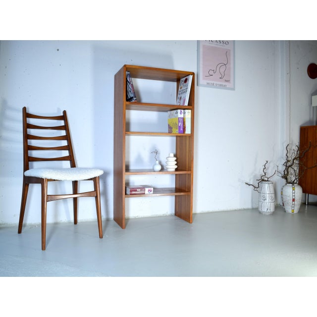 This is a slim Danish bookcase from the 1960s. The bookcase features a high-quality teak veneer with rounded corners. Two...