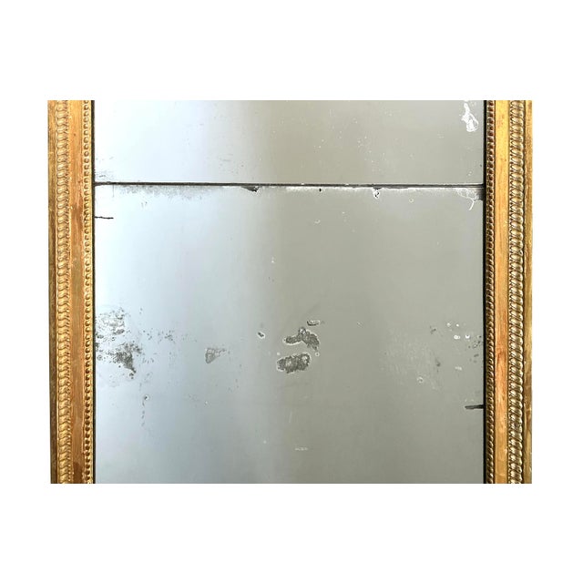 fitted with the original mercury split mirror plates within a carved giltwood frame with beaded slip surrounded by a...