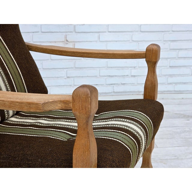 1970s, Danish armchair. Original striped green furniture wool, carved oak wood. Original very good condition: no smells,...