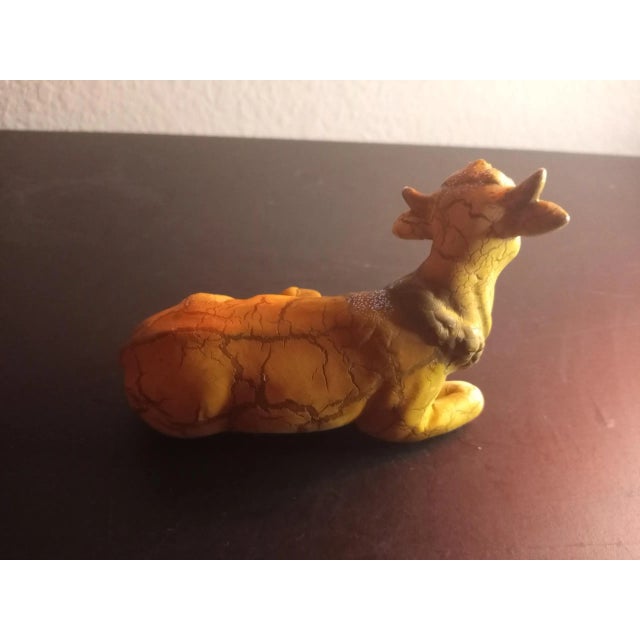 This is a Ceramic 4" Cow Figurine Procured at auction