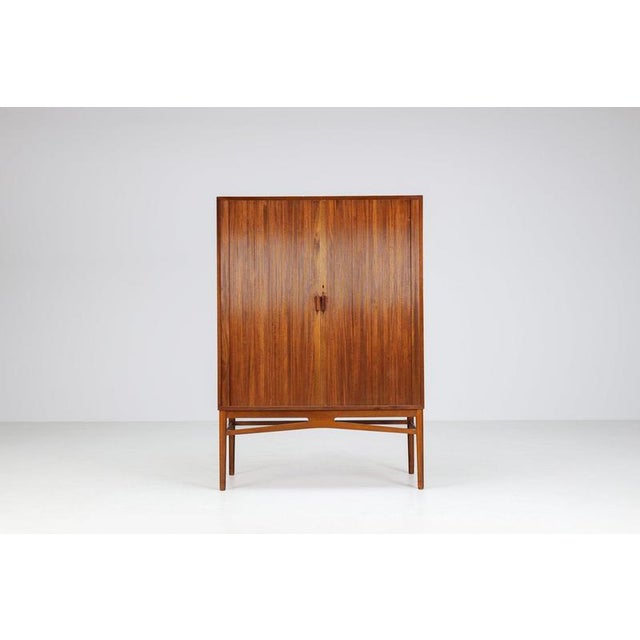 Danish high cabinet in teak with tambour doors, Denmark 1960s. An elegant Scandinavian modern cabinet characterized by its...